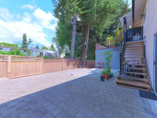 Discover this spacious backyard with a paved patio, perfect for outdoor entertaining.
