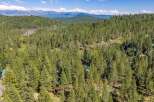 Nestled amidst a dense forest of towering pine trees, this property offers a secluded and serene mountain retreat.