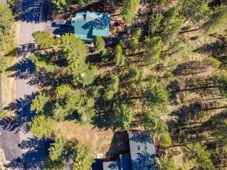 Discover this charming property nestled among mature pine trees, offering a serene and private setting.