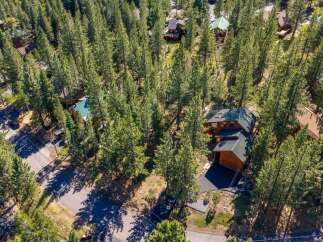 Nestled amidst towering pine trees, this property offers a serene mountain retreat.