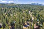 Nestled amidst a dense forest of tall pine trees, this property offers a serene and private mountain retreat.