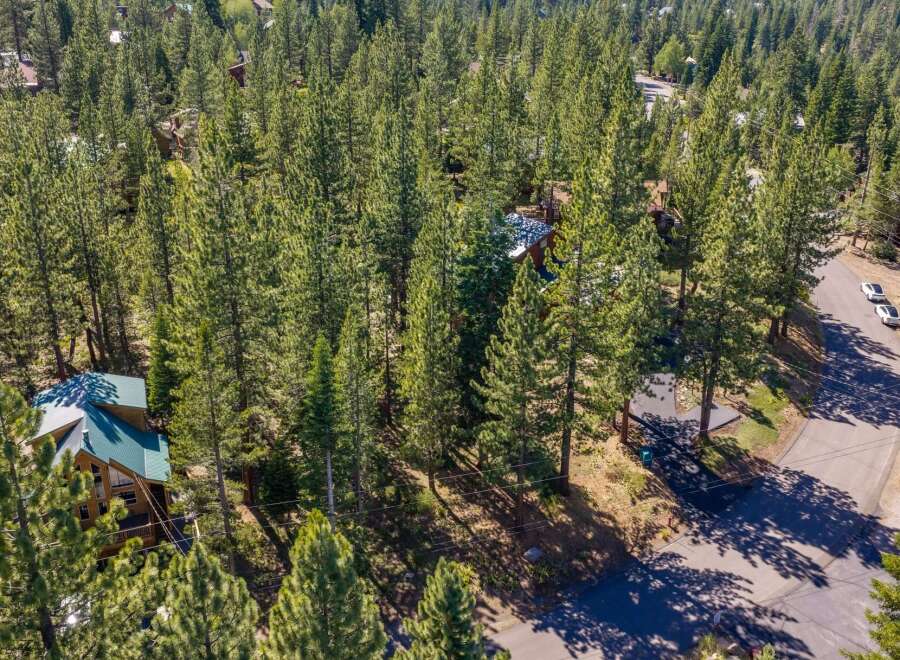 Nestled amidst a dense forest of mature pine trees, this property offers a secluded mountain retreat.