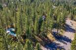 Nestled amidst a dense forest of mature pine trees, this property offers a secluded mountain retreat.