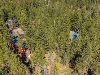 Nestled amidst a dense forest of mature pine trees, this property offers a secluded mountain retreat.