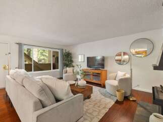 Experience cozy living in this inviting living room, featuring a plush sectional sofa perfect for relaxation.