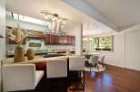 This spacious kitchen features rich cherry wood cabinets and a granite countertop island, perfect for casual dining or entertaining.