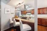 Discover this beautifully updated kitchen featuring rich wood cabinetry and elegant granite countertops.