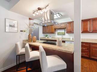 Discover this beautifully updated kitchen featuring rich wood cabinetry and elegant granite countertops.