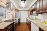 Discover this beautifully updated kitchen featuring rich cherry wood cabinets and elegant granite countertops.