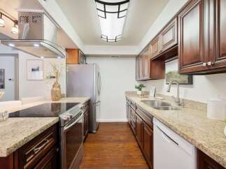 Discover this beautifully updated kitchen featuring rich cherry wood cabinets and elegant granite countertops.
