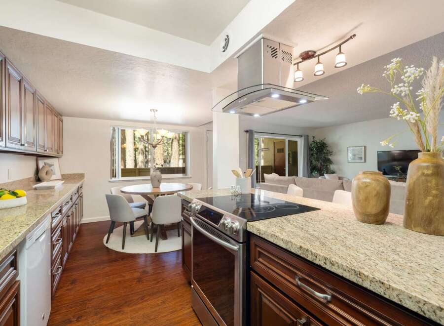 This spacious kitchen features granite countertops and ample cabinet space, perfect for any home chef.