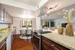 This spacious kitchen features granite countertops and ample cabinet space, perfect for any home chef.