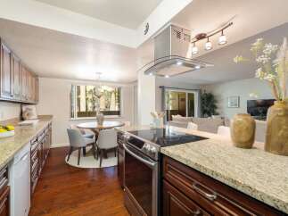 This spacious kitchen features granite countertops and ample cabinet space, perfect for any home chef.