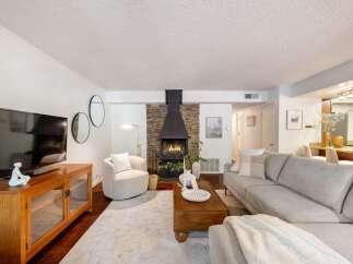 Cozy living room featuring a modern stone fireplace as the focal point, perfect for chilly evenings.