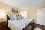 Experience ultimate comfort in this beautifully appointed bedroom, featuring a plush king-size bed adorned with soft, inviting pillows and a luxurious white duvet.