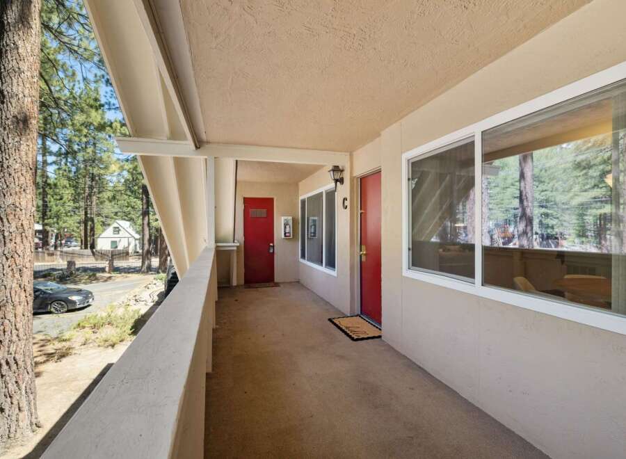 Discover this charming property featuring two inviting red doors, perfect for a duplex or multi-unit dwelling.