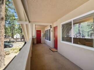 Discover this charming property featuring two inviting red doors, perfect for a duplex or multi-unit dwelling.