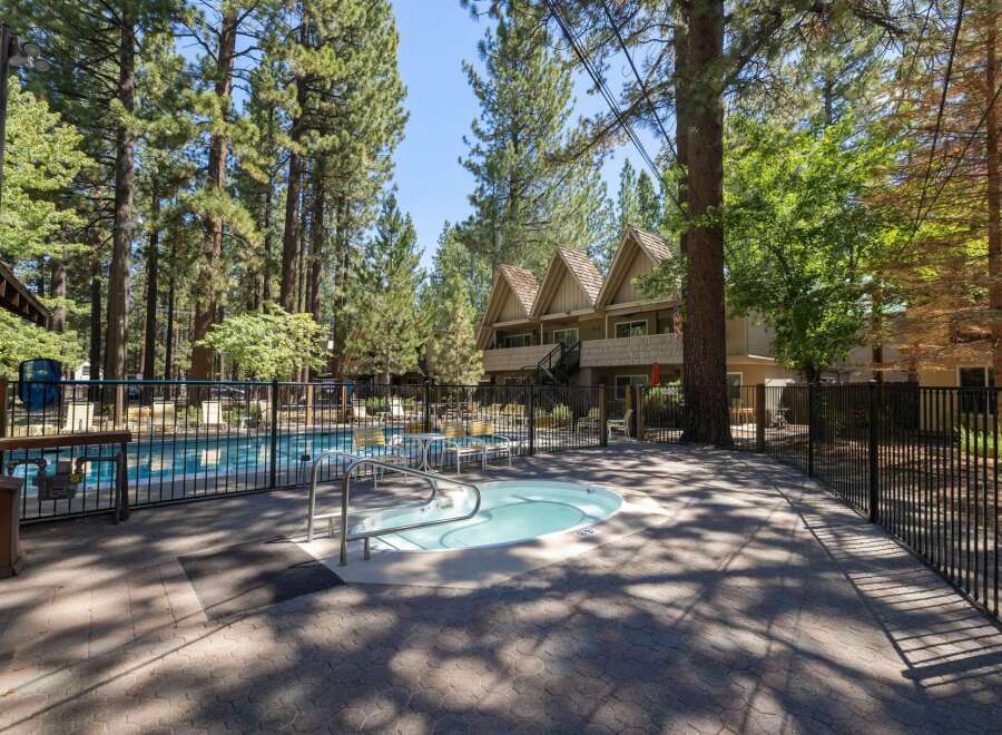 Enjoy a refreshing dip in the sparkling pool or relax in the soothing hot tub, surrounded by tall pine trees.