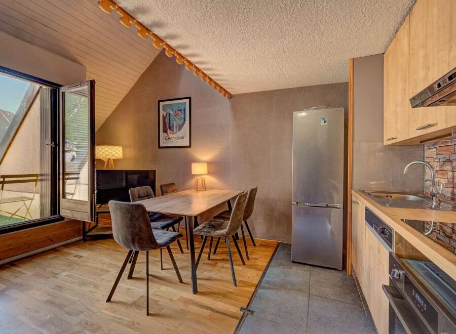 Experience comfortable living in this charming apartment featuring a dining area with plush seating perfect for family meals.