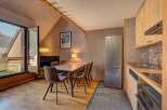 Experience comfortable living in this charming apartment featuring a dining area with plush seating perfect for family meals.
