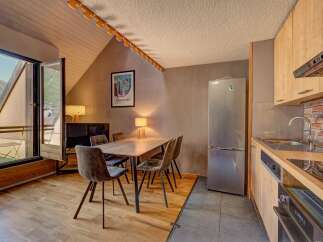 Experience comfortable living in this charming apartment featuring a dining area with plush seating perfect for family meals.