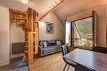 Discover this charming apartment featuring a unique spiral wooden staircase leading to the upper level.