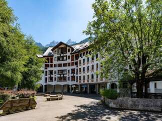 Discover this charming property nestled amidst lush greenery, offering stunning mountain views.