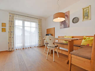 Enjoy a cozy dining experience in this charming space, featuring a rustic wooden bench and table set.