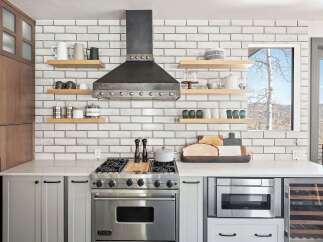 Experience culinary excellence in this modern kitchen, featuring a professional-grade Viking range and a sleek stainless steel hood.