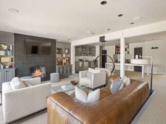 Experience ultimate comfort and style in this beautifully designed living space, featuring a cozy fireplace and a modern entertainment area.