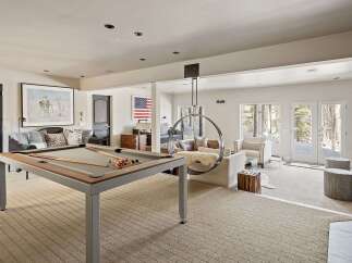 Experience ultimate relaxation and entertainment in this spacious recreational room, featuring a professional pool table for friendly games.