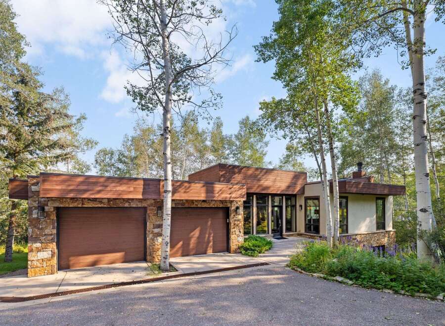 Experience modern mountain living in this stunning home, featuring a striking combination of stone and wood accents.