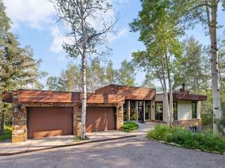 Experience modern mountain living in this stunning home, featuring a striking combination of stone and wood accents.