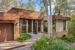 Discover modern mountain living in this stunning home, featuring a striking blend of natural stone and warm wood siding.