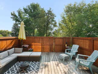 Enjoy outdoor living on this spacious wooden deck, perfect for entertaining or relaxing.