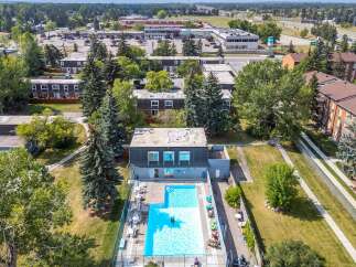 Enjoy a refreshing dip in the sparkling blue swimming pool, perfect for hot summer days.