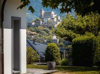 Experience breathtaking views from this property, featuring a majestic castle perched on a hillside in the distance.