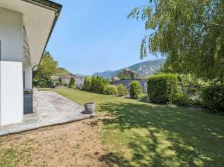 Enjoy the stunning mountain views from this beautiful property, featuring a spacious stone patio perfect for outdoor entertaining.