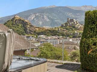 Experience ultimate relaxation with this stunning property featuring a private hot tub overlooking a picturesque town and historic castles.