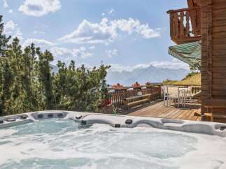 Experience ultimate relaxation with this stunning outdoor hot tub, offering breathtaking mountain views.