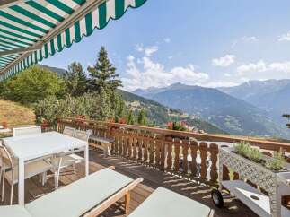 Enjoy breathtaking mountain views from this stunning balcony, perfect for outdoor dining and relaxation.
