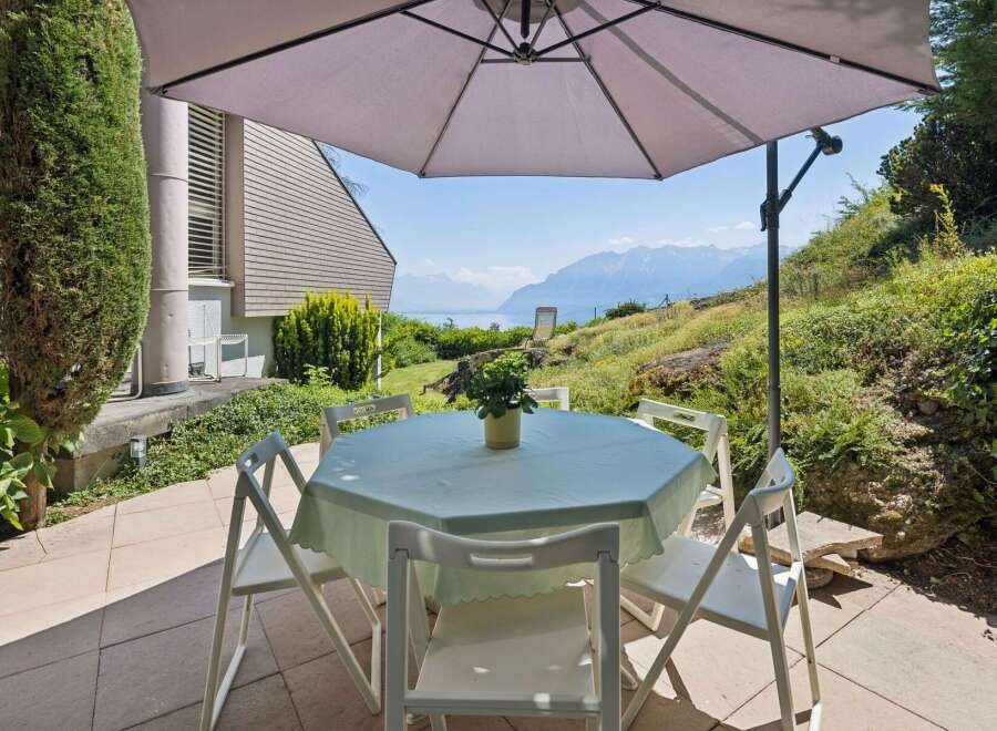 Enjoy breathtaking lake and mountain views from this charming outdoor dining area.