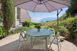 Enjoy breathtaking lake and mountain views from this charming outdoor dining area.