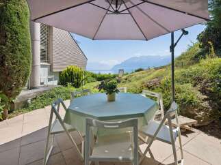 Enjoy breathtaking lake and mountain views from this charming outdoor dining area.