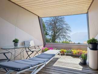 Enjoy breathtaking mountain and lake views from this charming balcony, perfect for relaxation and entertaining.