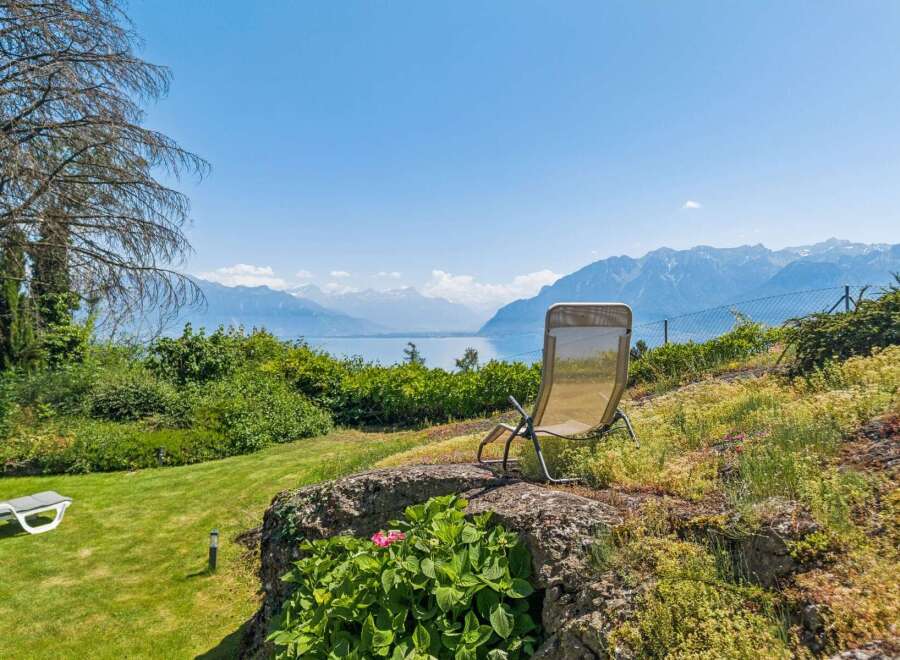 Enjoy breathtaking panoramic views of the lake and mountains from this stunning property.
