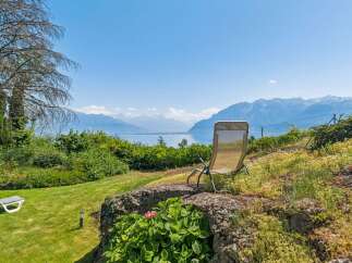 Enjoy breathtaking panoramic views of the lake and mountains from this stunning property.