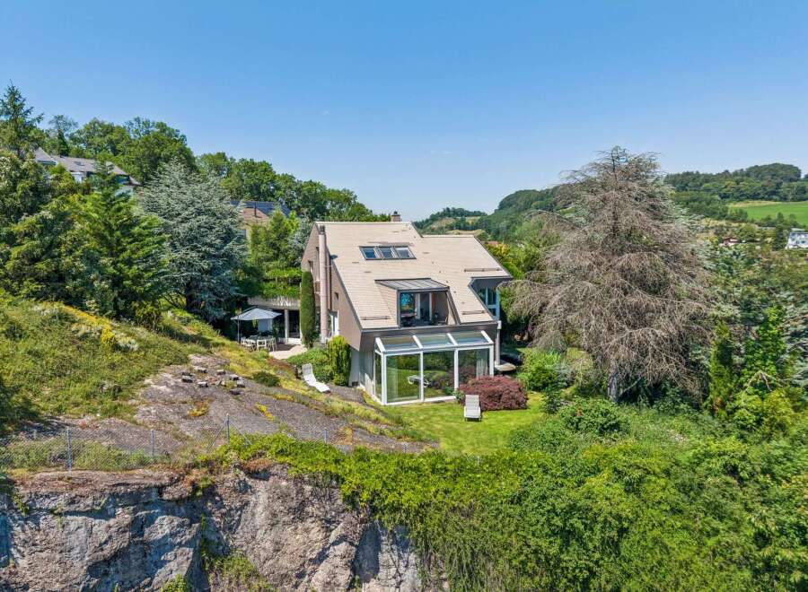 Nestled on a scenic hillside, this modern home offers breathtaking views and a serene living environment.