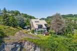 Nestled on a scenic hillside, this modern home offers breathtaking views and a serene living environment.