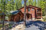 Nestled among tall pine trees, this stunning wooden home offers a serene mountain retreat.
